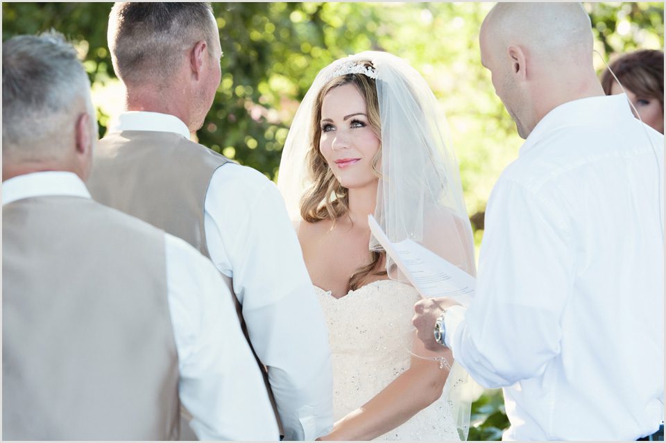bride gazes at groom during wedding ceremony