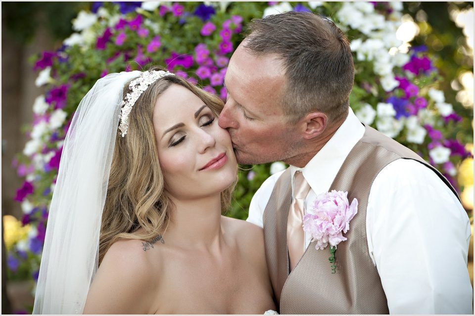 groom kisses brides cheek