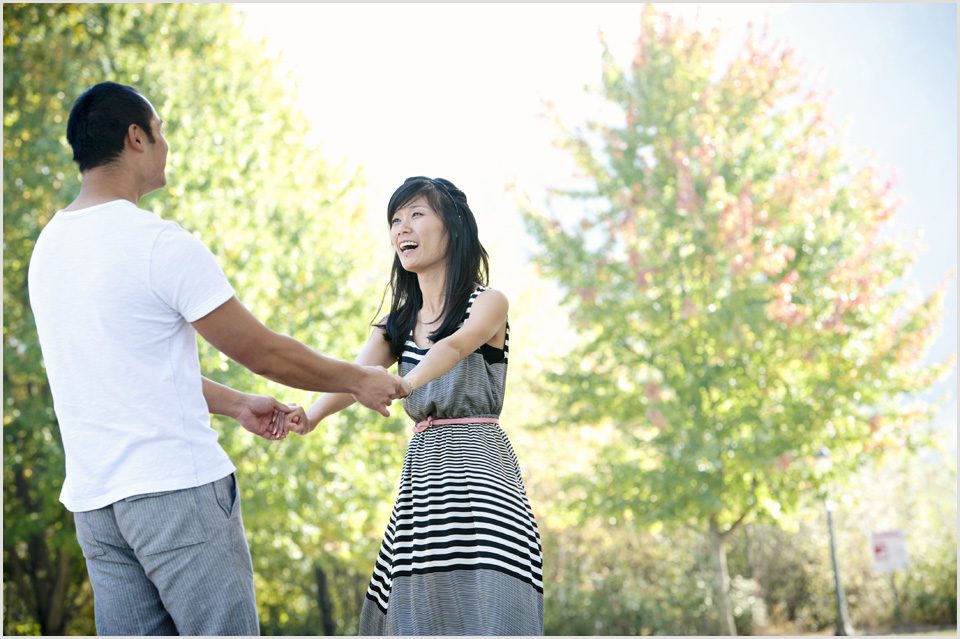 groom spins bride during photo shoot