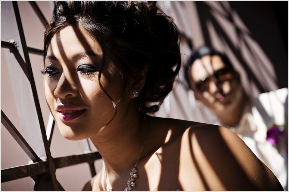 Vietnamese bride with her groom in the background