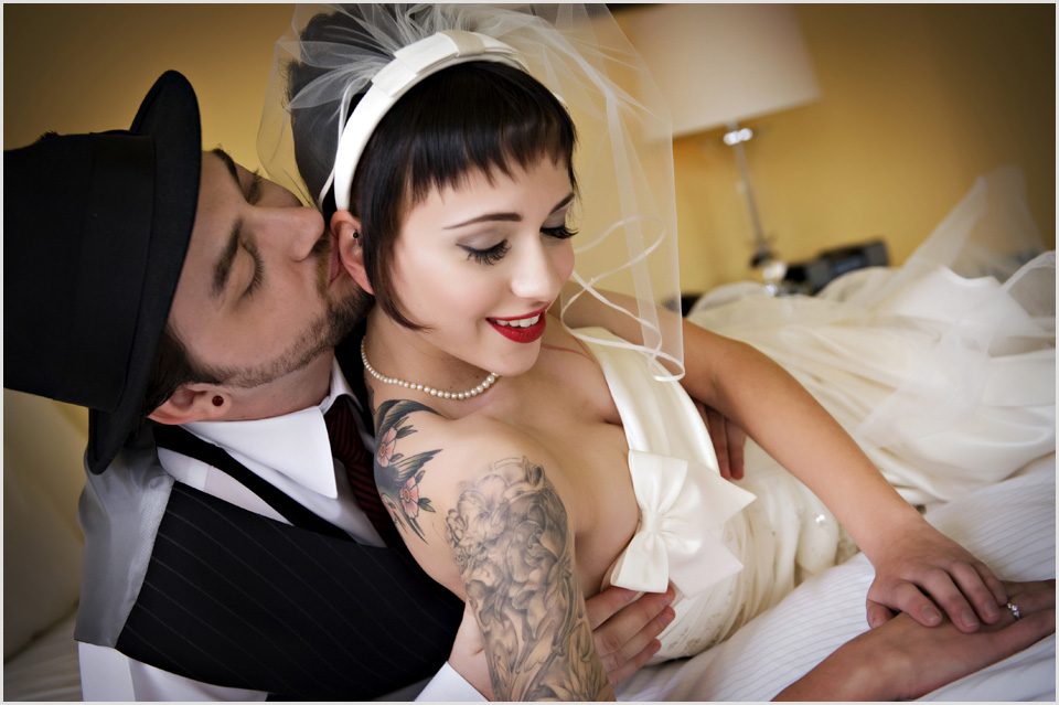 groom kisses rockabilly bride's ear
