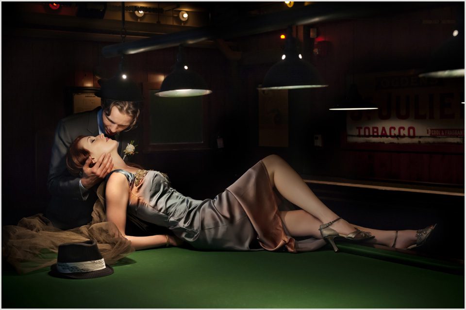 groom kisses bride on a pool table