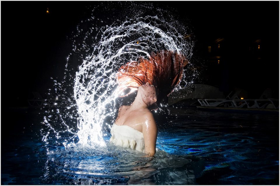 bride flips her hair in a swimming pool