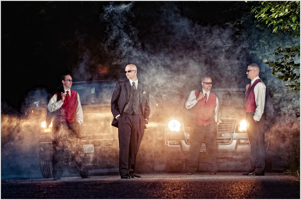 groom with his groomsmen with smoke and headlights