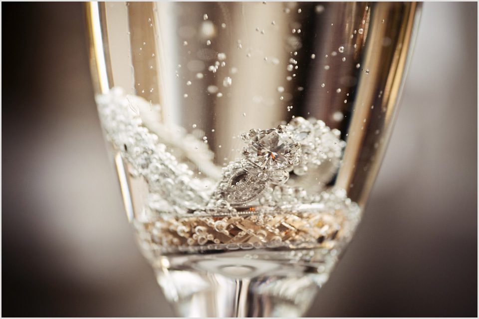wedding rings in a glass of champagne