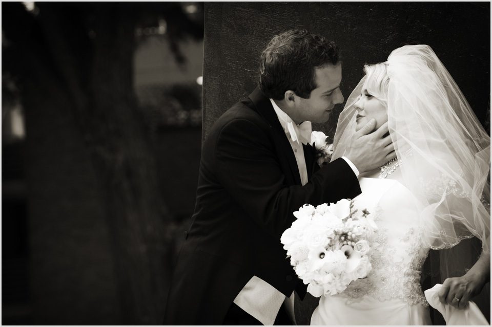 black and white photo of groom about to kiss bride