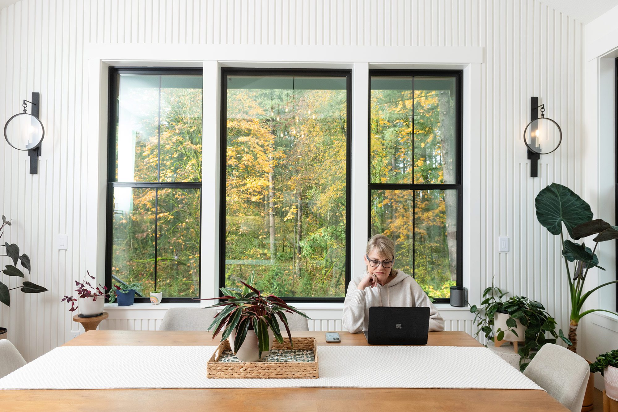 woman at a dining table working on her computer
